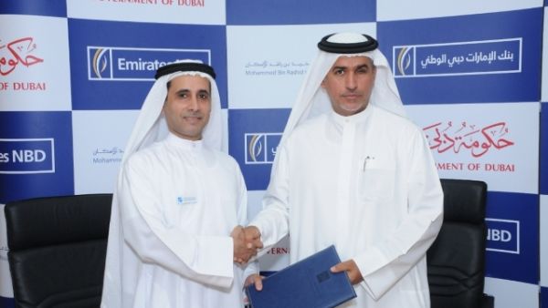 Mohammed Al Marri, Assistant Executive Director for Financial Affairs, MRHE and Jamal Bin Ghalaita, Group Deputy Chief Executive Officer, Emirates NBD, shaking hands after the signing
