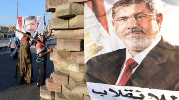 An image of deposed president Mohamed Morsi at a makeshift barricade on Nasr City's main street in Cairo, July 28, 2013 (AFP)