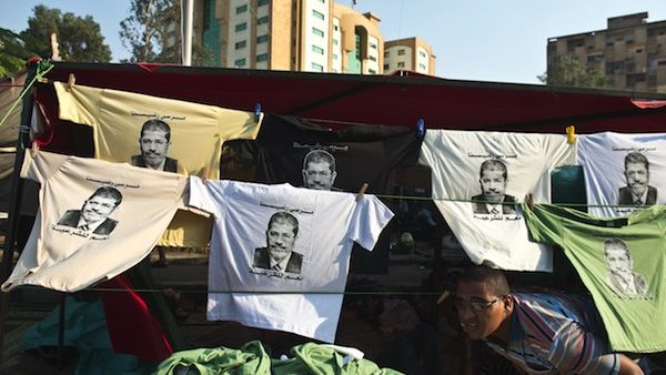 T-shirts bearing portraits of Egypt's deposed president Mohamed Morsi are put on display outside a tent during a sit-in organised by the Muslim Brotherhood in his support outside Rabaa al-Adawiya mosque in Cairo on August 4, 2013. (AFP)