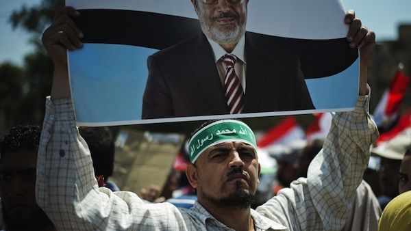 A protester holds a sign of Egyptian president Mohammed Morsi. (Source: AFP)