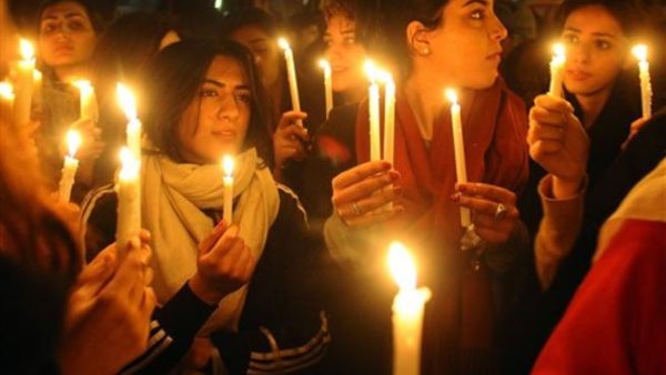 Pakistani civil society activists hold lit candles as they march in tribute to slain governor Punjab province Salman Taseer during a rally in Lahore on January 7, 2011. 