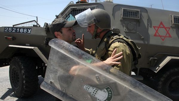 An Israeli soldier wags his finger at a Palestinian protester is seized by an during the evacuation of Palestinian protesters as they were trying to close the main road leading to the Israeli settlment of Efrata in the West bank town of Bethlehem on August 16, 2013 (AFP) An Israeli soldier wags his finger at a Palestinian protester is seized by an during the evacuation of Palestinian protesters as they were trying to close the main road leading to the Israeli settlment of Efrata in the West bank town of Bethlehem on August 16, 2013 (AFP)