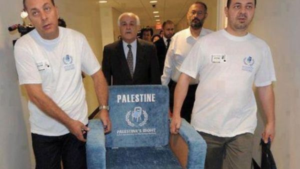 Members of the Palestinian delegation to the UN carry a chair similar to those used in the UN General Assembly.