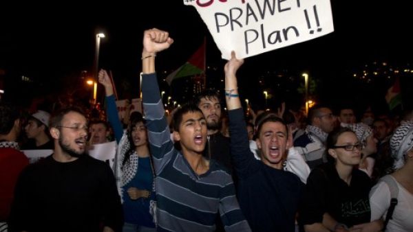 Arab-Israelis take part in a demonstration against the against the Prawer plan in the northern Israeli city of Haifa on November 30, 2013. The so-called Prawer-Begin Bill calls for the relocation of 30,000-40,000 Bedouin in the Negev - 80 percent of which support the law, according to Israeli official Dror Almog. (AFP)
