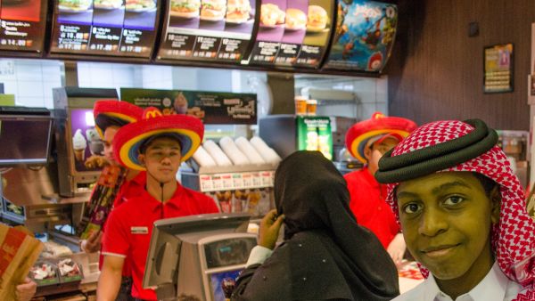 A Qatari mother and son order dinner at a McDonalds in Doha (Albawaba/J. Zach Hollo)