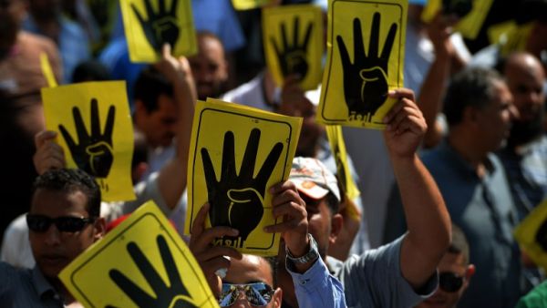 Supporters of ousted Islamist president Mohamed Morsi wave the 'rabaa' sign of four fingers in a show of solidarity with the Muslim Brotherhood movement in Cairo. (AFP/File)