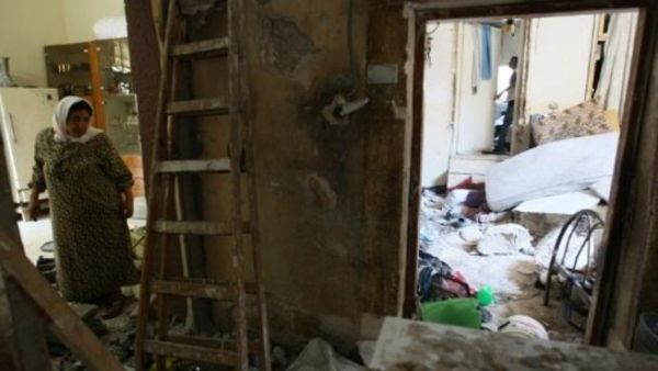 One woman stands in the wreckage of her home in Nablus