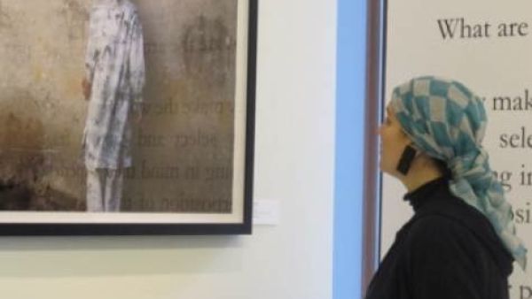 Saudi Princess Reem Al Faisal looks at a picture taken by a photographer exhibiting his work in her gallery in Dubai. (Jumana Al Tamimi/Gulf News)
