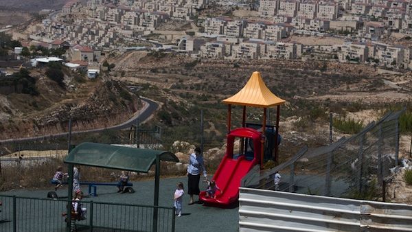 A Jewish woman looks after children at a play ground in the Jewish settlement of Beitar Elit at the Israeli occupied West Bank on August 12, 2013. (AFP)