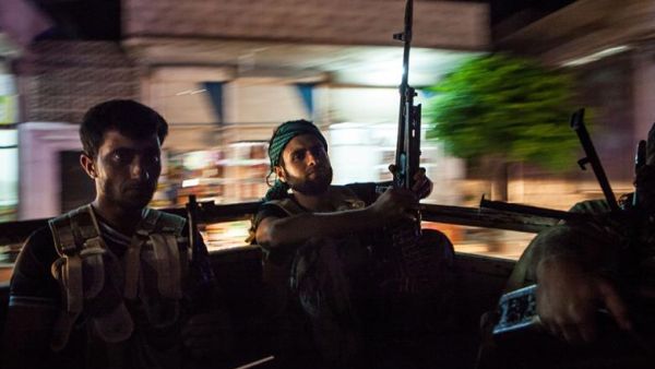 Syrian rebels head to the town of Bsankol in the northwestern province of Idlib to join comrades fighting regime forces for the control of the highway that connects Idlib with Latakia on 11 July 2013. (AFP/File)