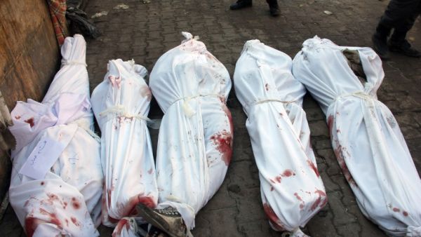 Bodies of victims from an airstrike on the Maadi neighbourhood of the northern Syrian city of Aleppo are seen on the ground wrapped in shrouds on December 17, 2013. This picture was taken on the third day of the bombing campaign - it is now entering its ninth. (AFP)
