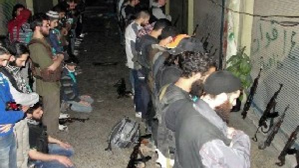 Rebel fighters pray in Syria's central city of Homs on June 17. (AFP/Shaams)