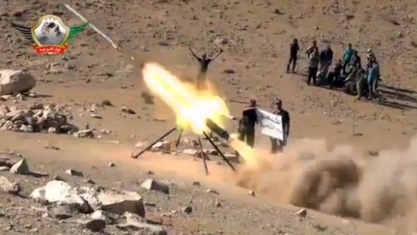 An image grab taken from a video uploaded on YouTube on May 29, 2013 allegedly shows members of the Al-Tawhid brigade firing missiles from Syria towards the Lebanese town of Hermel, a few kilometres from Baalbek in the Bekaa valley. (AFP)