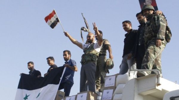 Syrian troops stand victorious in the rubble of Qusair on Wednesday. AFP Photo