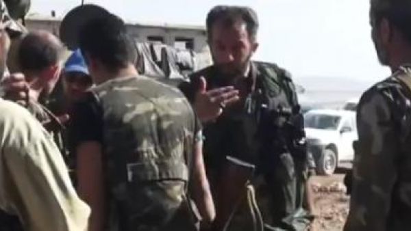 A screenshot of an Iranian military adviser talking to Syrian army troops (Al Bawaba/YouTube)