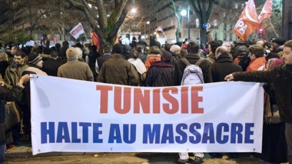 People hold a banner reading "Tunisia, stop massacre" during a demonstration against Tunisian President Zine El Abidine Ben Ali on January 11, 2011 in Paris