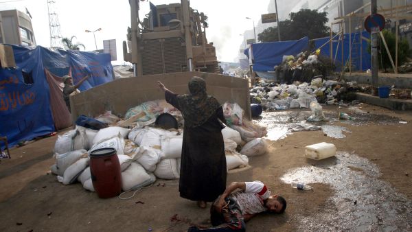 An Egyptian woman tries to stop a military bulldozer (AFP/MOHAMMED ABDEL MONEIM)