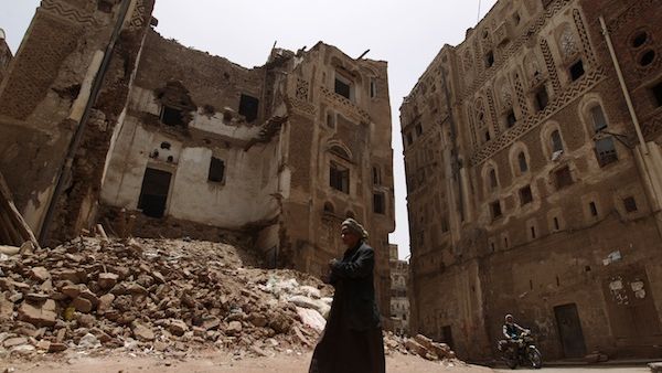 Yemeni man walks past a damaged traditional house in the historical quarter in the Yemeni capital Sanaa on Tuesday. AFP Photo