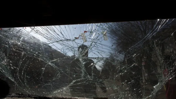 Glass is smashed on a car as Afghan soldiers block the scene after a suicide bomber&amp;#039;s attack on January 12, 2011 in Kabul.