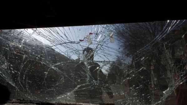 Glass is smashed on a car as Afghan soldiers block the scene after a suicide bomber&amp;#039;s attack on January 12, 2011 in Kabul.