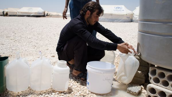 A Syrian refugee in Jordan's Zaatari camp retrieves water. Jordan is one of the most water-scarce countries on earth (File Archive/AFP)