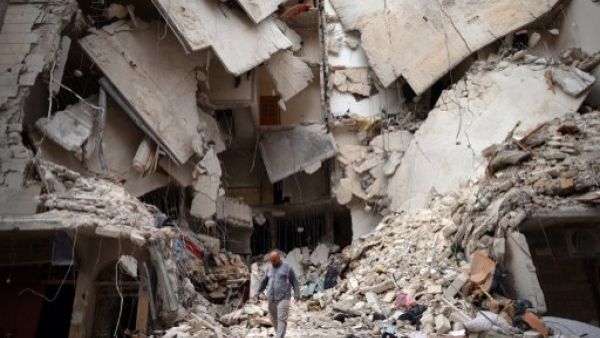 A Syrian man walks amid destruction in the northern Syrian city of Aleppo on Wednesday. (Photo:  AFP / DIMITAR DILKOFF) 