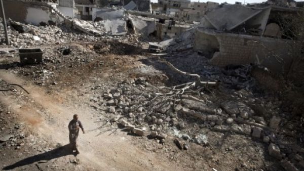 A man walks through a destroyed residential area of the Syrian city of Saraqib, southwest of Aleppo, on September 9, 2013, following repeated airstrikes by government forces. The Free Syrian Army have rejected the latest solution to the Syria crisis offered by the US and Russia. (AFP)
