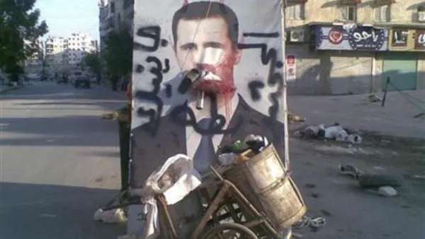 صورة مشوهة للرئيس السوري بشار الاسد في حلب 