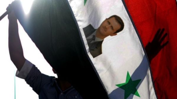 A top Hezbollah official apparently admitted that the Syrian government was behind the use of chemical weapons in Syria, according to German intelligence. Pro-Assad Turks wave flags with his face on it in Hatay, Turkey. (AFP)