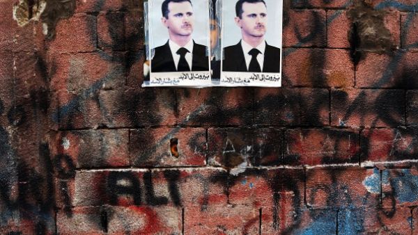 Syrian president Bashar al-Assad's picture hangs on a wall in a poor area of Beirut with a high concentration of Syrian refugees.