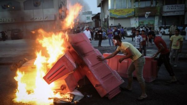 Bahraini protesters put fire on barricades during clashes with riot police following a protest against the Formula One Grand Prix on Friday in the village of Sanabis, west of Manama. (Photo: AFP PHOTO/MOHAMMED AL-SHAIKH)