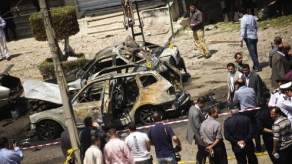 gyptians gather at the site of a bomb that targeted the convoy of the Egyptian Interior Minister Mohammed Ibrahim in Cairo on September 5, 2013. (AFP)