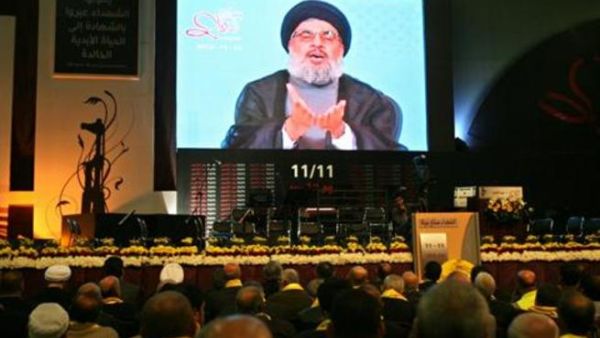 Hezbollah leader Sayyed Hasan Nasrallah speaks on a TV screen during a ceremony in Beirut  (The Daily Star/Hasan Shaaban)