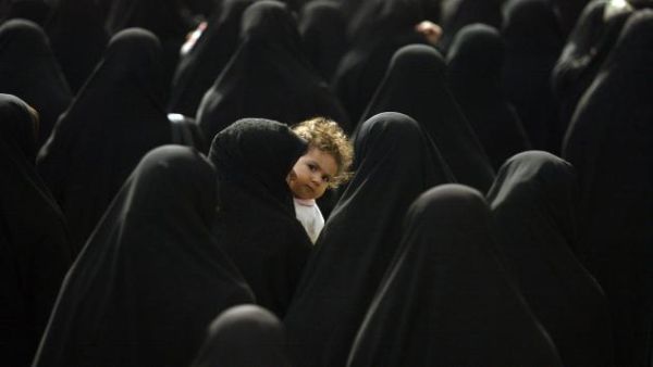An Iranian woman carries her child. (UPI File Photo/Mohammad Kheirkhah) 