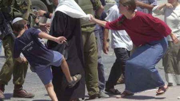 Israeli settlers harass a Palestinian woman in the West Bank (File)