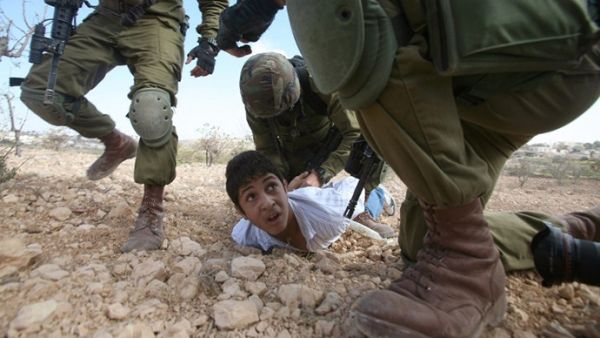 A Palestinian kid was arrested last year for throwing stones at Israeli soldiers (Hazem Bader/AFP)