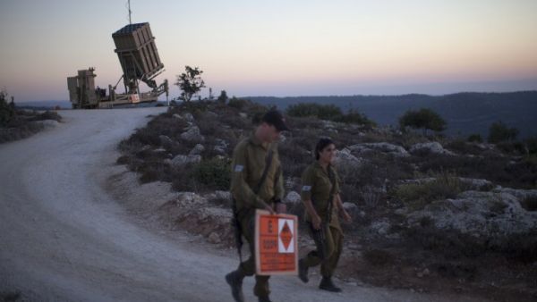 Israeli soldiers walk by an "Iron Dome" battery, a short-range missile defence system in Jerusalem. An Israeli official said Thursday that he supports the Russian plan that seeks to destroy Syria's chemical weapons. (AFP)
