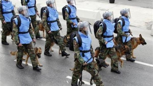 جنود لبنانيون يمسكون كلابا يشاكون في عرض عسكري
