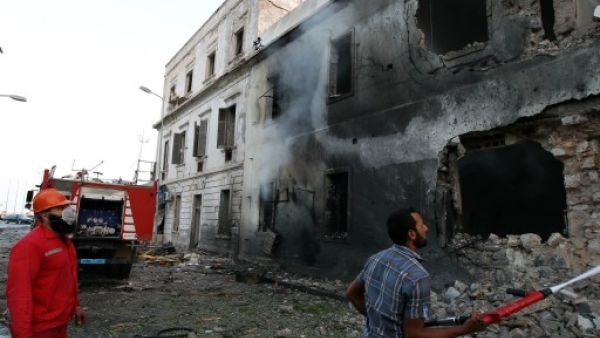 Libyan firefighters extinguish a fire caused by a powerful blast near a foreign ministry building on September 11, 2013 in the eastern Libyan city of Benghazi. (AFP)