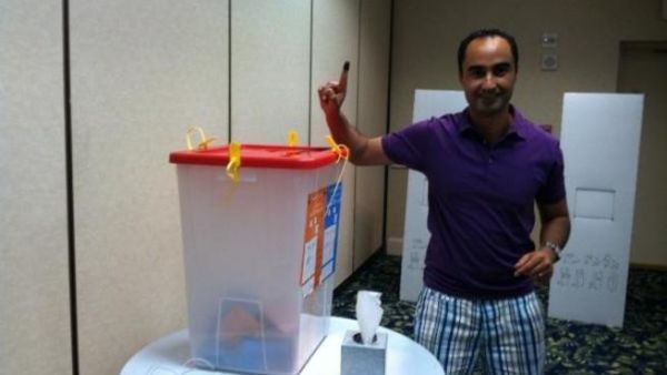 One Libyan proudly shows off his purple finger