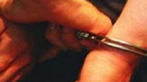 A prisoner in handcuffs.