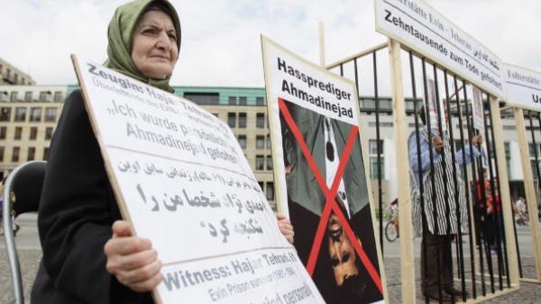 Witness Hajar Tehrani, Evin prison survivor (1981-1984), who was personally tortured by Iranian President Mahmoud Ahmadinejad, joins Iranian exiles protesting against stoning and condemns the forced concessions
