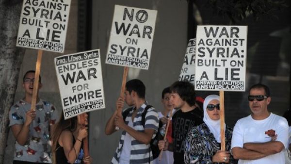 People demonstrate against a US-led strike on Syria in downtown Los Angeles on August 31, 2013. (AFP)