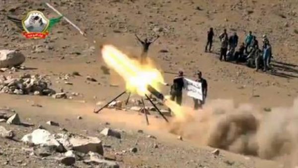 An image grab taken from a video uploaded on YouTube on May 29, 2013 allegedly shows members of the Al-Tawhid brigade firing missiles from Syria towards the Lebanese town of Hermel, a few kilometres from Baalbek in the Bekaa valley. AFP photo/YouTube
