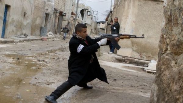 A Syrian rebel aims his weapon during clashes with government forces in the streets near Aleppo international airport in northern Syria on Monday (Photo: AFP/Stephen J. Boitano) - Picture used for illustrative purposes - A Syrian rebel aims his weapon during clashes with government forces in the streets near Aleppo international airport in northern Syria on Monday (Photo: AFP/Stephen J. Boitano) - Picture used for illustrative purposes -