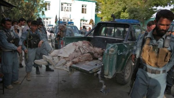 Afghanistan policemen stand near bodies of Taliban fighters, as they lie on a police vehicle in the grounds of the main hospital in Ghazni on September 1, 2013. (AFP)