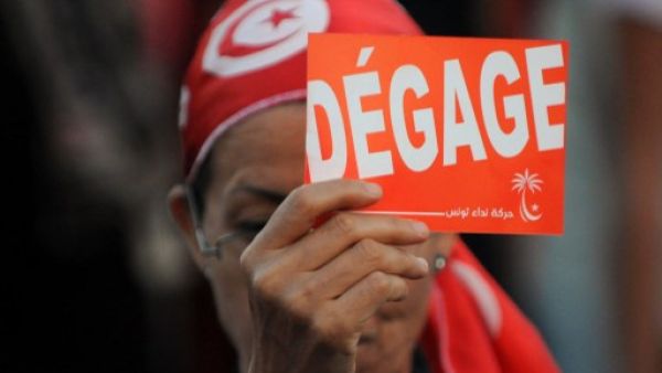 A Tunisian demonstrator holds a poster during a demonstration against the country's Islamist-led government in Tunis on August 24, 2013. (AFP)