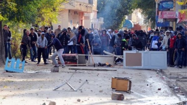 Tunisian protestors hurled stones at security officials late last week, calling for the ruling Islamist party Ennahda's resignation (Fethi Balaid/AFP) Tunisian protestors hurled stones at security officials late last week, calling for the ruling Islamist party Ennahda's resignation (Fethi Balaid/AFP)