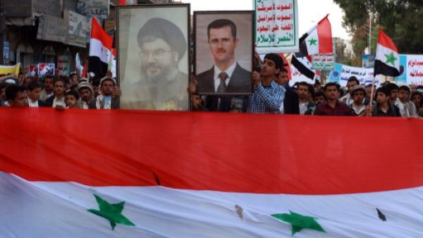 Yemeni supporters of Shiite al-Huthi group hold up a portrait of Lebanon's Shiite movement Hezbollah chief Hassan Nasarallah(L) and of Syria's President Bashar al-Assad during a demonstration in Yemen. (AFP)