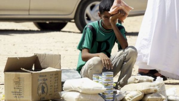 A Syrian refugee boy sits on the side of the road at Zaatari refugee camp in Jordan (AFP)